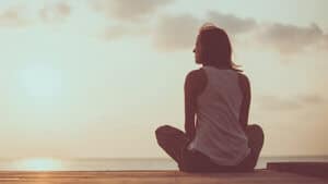 girl meditates outside a holistic addiction treatment center